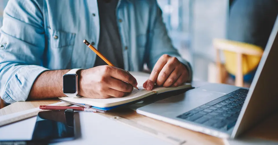 Person writing at a desk