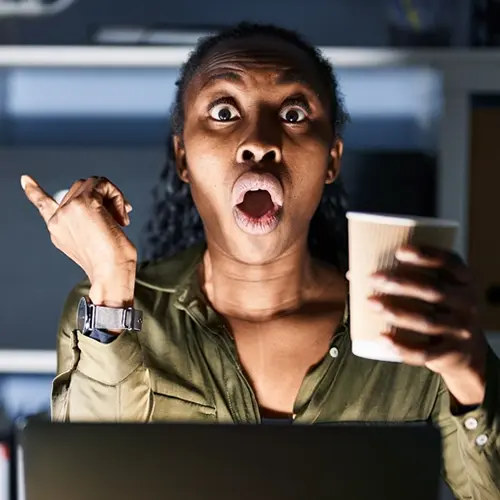MI Nonprofit Relief Ad - Surprised woman at a computer holding a coffee